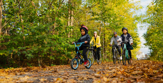 a family riding bicycles on a trail