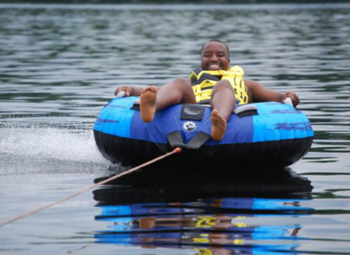 a man tubing on a lake