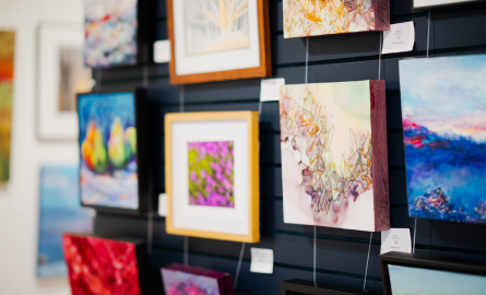 a variety of colourful artworks displayed in a gallery