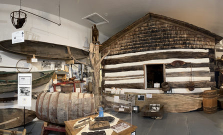 a museum full of artifacts including a log cabin