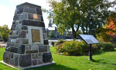 a rock cairn with an interpretive plaque