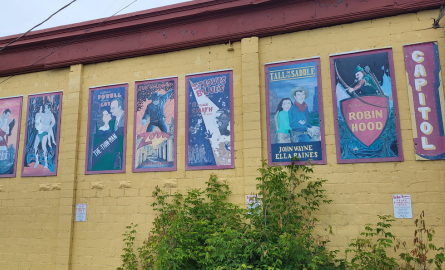 a series of movie posters painted on a building