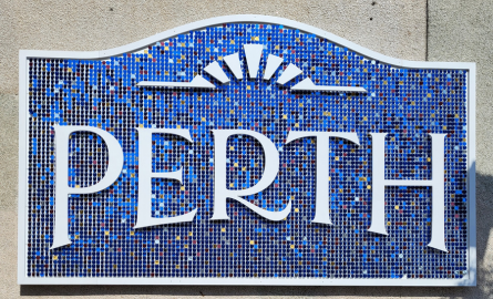 a blue and white sign constructed of large reflective circles, spelling "Perth"