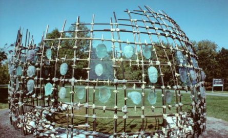 a metal framework with glass faces adorning it